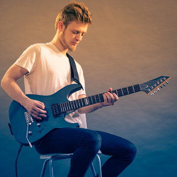 Man playing on electric guitar