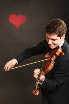 Man man dressed elegantly playing violin