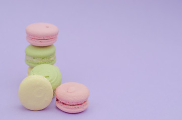Dessert macaroons on a purple background.