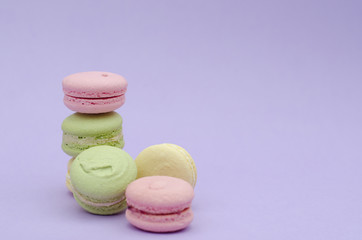 Dessert macaroons on a purple background.