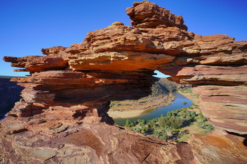 a view from the middle of hollow rock formation facing a river in the kalbarri western australia at daylight