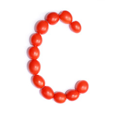 The letter C is made of tomato. Symbol of the English alphabet of tomato on a white background.
