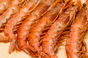 long appetizing langoustines lots of fresh delicacies on a wooden board background culinary base prepare seafood