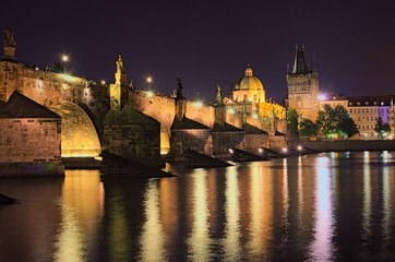 Obraz premium Summer night view of historical part of Prague. Vltava river, Mala Strana Bridge Tower and Charles Bridge with illumination. Prague, Czech Republic