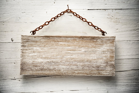 wooden signboard hanging on a chain