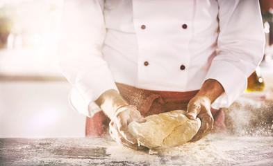 Chef or baker preparing a portion of fresh dough