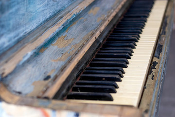 Old vintage style piano with scuffed paint
