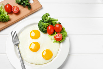 fried eggs and fresh vegetables on the table