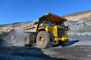 Obraz premium Large quarry dump truck. Loading the rock in the dumper. Loading coal into body work truck