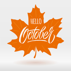 Hello October lettering with maple leaf on light background. Modern brush calligraphy. Autumn banner. Vector typography for social media banner, greeting card, poster, flyer. Vector illustration.
