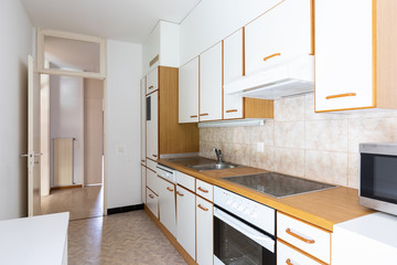 White and wooden vintage kitchen with tiles