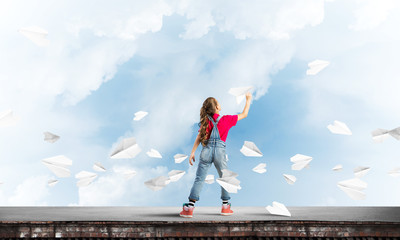 Concept of careless happy childhood with girl dreaming to become pilot