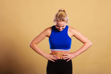 Fit woman suffering from stomach pain