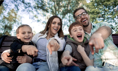Obraz premium close up.smiling family pointing at you