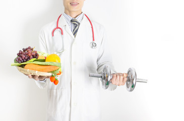 Doctor holding tray with heart healthy foods and dumbbell ,check a healthy eating ,workout and fitness dieting ,fitness and weight loss concept