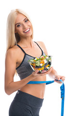 Woman in sportswear with tape measure and salad, isolated