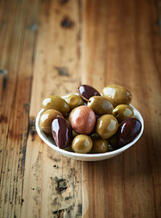 Assorted olives in a white dish. Mediterranean cuisine. Natural food ingredients