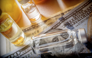 vials with different substances over dollar, concept of copayment
