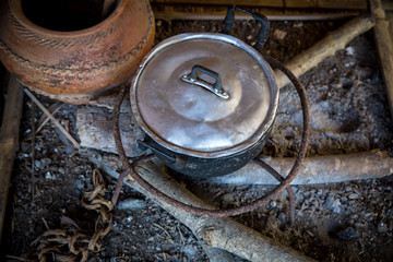 old and dirty pot on timber without fire. countryside lifestyle. ancient lifestyle without electricity. heat energy from firewood.