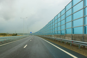 Noise-absorbing screens on the new road A-290 (formerly M25) on the Taman Peninsula on a cloudy autumn day