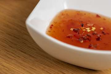 sweet and chilli sauce bowl on wooden table