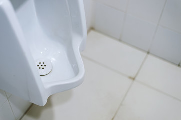 Fototapeta premium closeup old urinals (chamber pot) in toilet with soft-focus in the background. over light