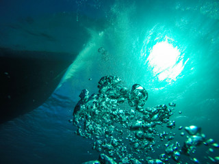 Air Bubbles Going up to the Surface  towards the Sun and the Dive Boat in the Red Sea in Egypt