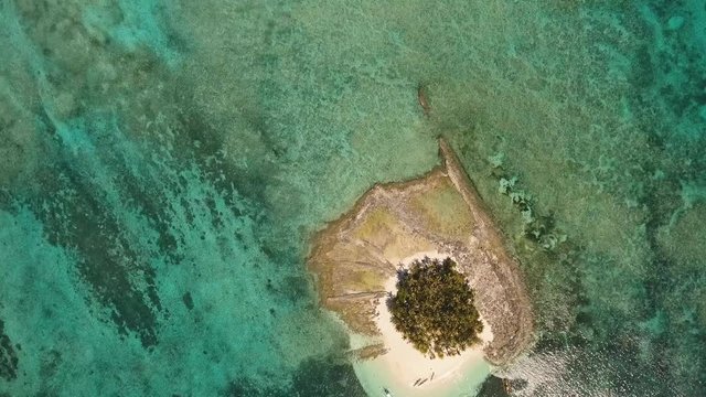 aerial footage tropical island with beach and palm trees lagoon with turquoise water Sea tropical landscape Guyam island, Philippines, Siargao. Travel concept Aerial video