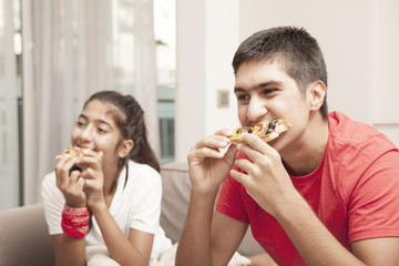 kids eating pizza and watching television