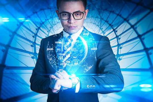 The abstract image of the businessman looking to the virtual hologram on smart watch and element of this image furnished by Nasa. the concept of communication network, internet of things and future.