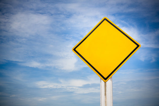 Blank on traffic sign on yellow background with cloudy blue sky. symbol for transportation regulations. image for background, wallpaper and backdrop.