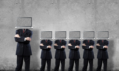 Businessmen with laptops instead of head.