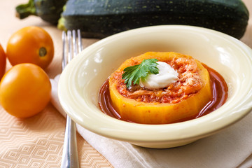 Zucchini stuffed with meat and vegetables, stewed in tomato sauce