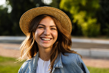Close up of a joyful young girl in summer hat