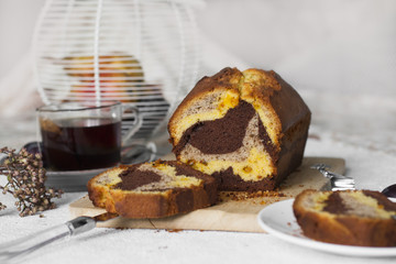Homemade marble plum cake, three colours made with saffron, walnuts and chocolate.