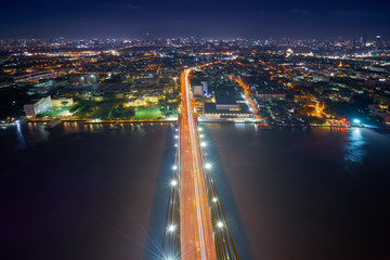 Fototapeta na wymiar night cityscape with light bridge to metropolis