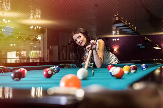 Woman Playing Billiard And Using Bridge Rack