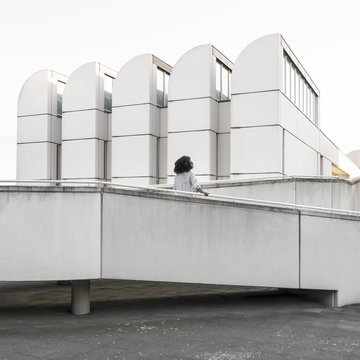 Woman surrounded by white Bauhaus architecture