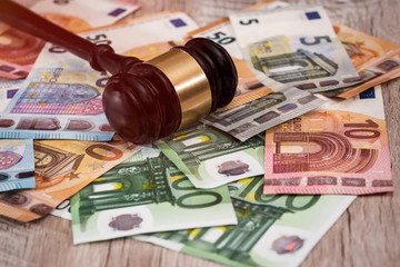 Judge's gavel on euro banknotes close up