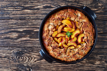 Homemade Peach Cobbler in a black dish
