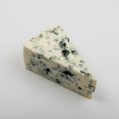 Piece of Blue Cheese on White Background Close Up