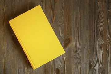 Yellow book on the table - 223182612