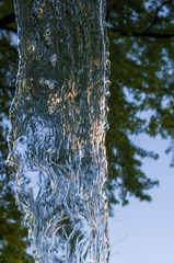 transparent falling water vertical flows, close up