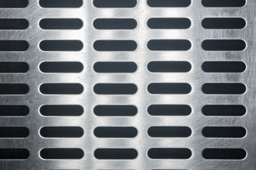 stainless steel grating with oblong holes, close up