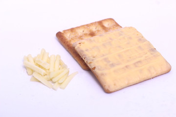 piece cheese beside cracker