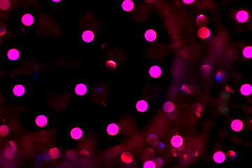 Abstract purple christmas bokeh lights isolated on black background. Christmas tree light background. New year decorations. Abstract lights on black. Winter theme.