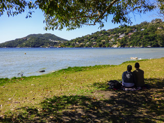 Fototapeta na wymiar Couple enjoying the view at Lagoa da Conceicao in Florianopolis, Brazil