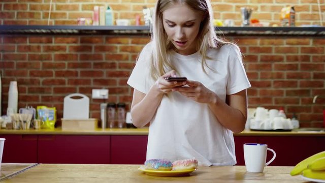 Beautiful woman takes picture of her breakfast