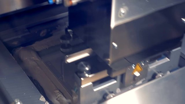 Industrial pressing machine add thermal paste on a computer component.