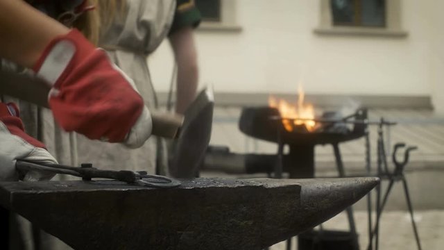 Female Blacksmith Crafting a Horseshoe